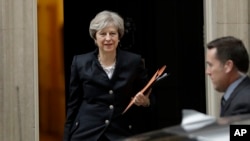 British Prime Minister Theresa May leaves 10 Downing Street to deliver a statement on Brexit to Parliament in London, Oct. 9, 2017.