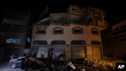 Palestinians check the damage of a house targeted by Israeli missile strikes in Gaza City, Nov. 12, 2019. 