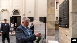  Szabolcs Szit, Director of the Holocaust Memorial Center, lays a wreath at a memorial plaque dedicated to Emil Wiesmeyer, who helped to save the lives of thousands of Jewish Hungarians during WWII. Swedish Ambassador to Hungary Niclas Touve, left, looks on during an unveiling ceremony at HMC in Budapest, Hungary, Oct. 18, 2017. 