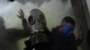 FILE - A supporter of U.S. President Donald Trump wears a gas mask as he protests after storming the U.S. Capitol, Jan. 6, 2021.