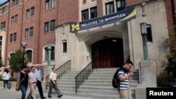 FILE - People walk by a building on the University of Michigan campus in Ann Arbor, Michigan, Sept. 19, 2018.