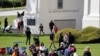 FILE - People picnic, play and walk at Peace Arch Park in Blaine, Washington, May 17, 2020. As Father's Day is observed in the United States June 21, 2020, many corovavirus restrictions have been eased in some areas of the country.