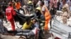 Rescuers carry away a man who was injured by a blast in the Somali capital of Mogadishu, Feb. 4, 2019.