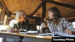 Corinne Gaby, right, works with her teacher, Linda Geary, during class Oct. 17 at Notch Peak Elementary. The school is housed in a horse barn two miles from Gaby's home. (Shannon Broderick / Laramie Daily Boomerang)