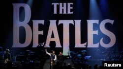 FILE - Paul McCartney and Ringo Starr perform during the taping of "The Night That Changed America: A GRAMMY Salute To The Beatles" in Los Angeles on Jan. 27, 2014. The Beatles are releasing their final single, "Now and Then," in November 2023.