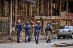 FILE - Ugandan security forces patrol on a street in Kampala, Uganda, Nov. 19, 2020.