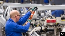 Workers complete car bodies at the plant of the German manufacturer Volkswagen AG in Zwickau, Germany, Jan. 22, 2018. President Trump vowed to tax European cars if the EU retaliates against his plans to tax imported steel and aluminum.