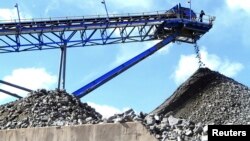 FILE - A conveyor belt carries ore extracted at Mimosa Platinum mine about 400km (249 miles) south of the capital Harare, Zimbabwe, Feb. 16, 2012.