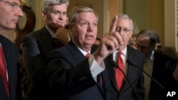 Sen. Lindsey Graham, R-S.C., joined by, from left, Sen. John Barrasso, R-Wyo., Sen. Bill Cassidy, R-La., and Senate Majority Leader Mitch McConnell, R-Ky., speaks to reporters as they faced assured defeat on the Graham-Cassidy bill, the GOP's latest attempt to repeal the Obama health care law, in Washington, Sept. 26, 2017. 