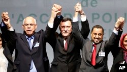 From left to right, Mohammed Chouaib of Libya's U.N.-recognized government; Fayez Sarraj, interim prime minister, and Dr. Saleh Almkhozom of the Libyan General National Congress, react after signing a U.N.-sponsored deal aiming to end Libya's conflict, Dec. 17, 2015, in Sikhrat, Morocco.