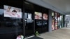 Flowers are seen laid in front of the Young's Asian Massage following the deadly shootings in Acworth, Georgia, March 17, 2021. 