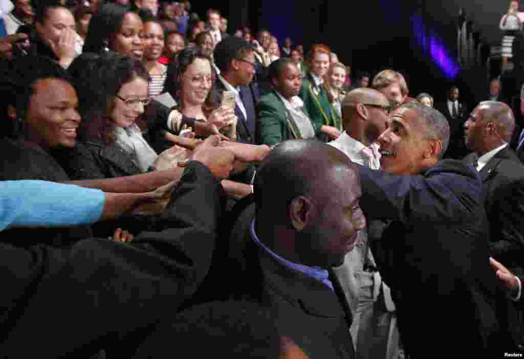U.S. President Barack Obama greets participants at a town hall-style meeting with young African leaders at the University of Johannesburg in Soweto, June 29, 2013.