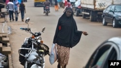 A Muslim woman walks in the Brituetterie district of Yaounde, Cameroon, July 16, 2015.
