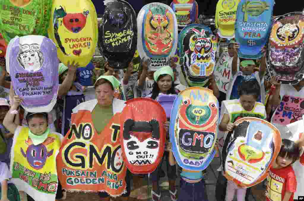 Mothers and children display painted baby tubs which they themselves designed during a protest on World Environment Day at suburban Quezon city northeast of Manila, Philippines.