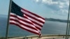 The U.S. flag waves outside the newly opened U.S. Embassy, overlooking Havana's seaside boulevard, the Malecon in Cuba, Aug. 14, 2015. 