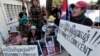 Boeung Kak lake community's land activists shout slogans with a poster of detained Tep Vanny during a rally in front of an appeals court in Phnom Penh, Cambodia, Tuesday, Aug. 8, 2017. The court upheld a 2 ½ year prison term against Tep Vanny, a prominent land rights activist on charges of committing violence at a protest she helped lead outside of Prime Minister Hun Sen's residence more than three years ago. (AP Photo/Heng Sinith)