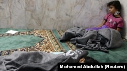 Girls who survived from what activists alleged was a gas attack by the Syrian government rest in a mosque in the Duma neighborhood of Damascus on August 21, 2013. 