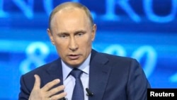Russian President Vladimir Putin takes questions as part of a live broadcast in Moscow, April 25, 2013.