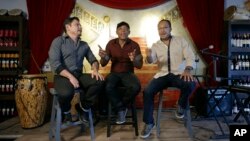 Members of the Colombian salsa band Sonora Carruseles, Leonardo Sierra, left, Daniel Marmolejo, center, and Jans Certuche, right, sing one of their hits during an interview in Doral, Florida, Aug. 17, 2015.