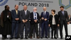 Heads of the delegations react at the end of the final session of the COP24 summit on climate change in Katowice, Poland, Dec. 15, 2018.