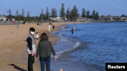 People enjoy the sunshine, as Victoria state begins easing coronavirus disease (COVID-19) restrictions, at Elwood beach in Melbourne, Australia, Sept. 14, 2020.