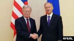 U.S. national-security adviser John Bolton (left) shakes hands with Russian Security Council Secretary Nikolai Patrushev