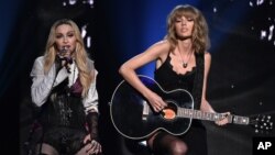 Madonna, left, and Taylor Swift perform on stage at the iHeartRadio Music Awards at The Shrine Auditorium in Los Angeles, March 29, 2015.