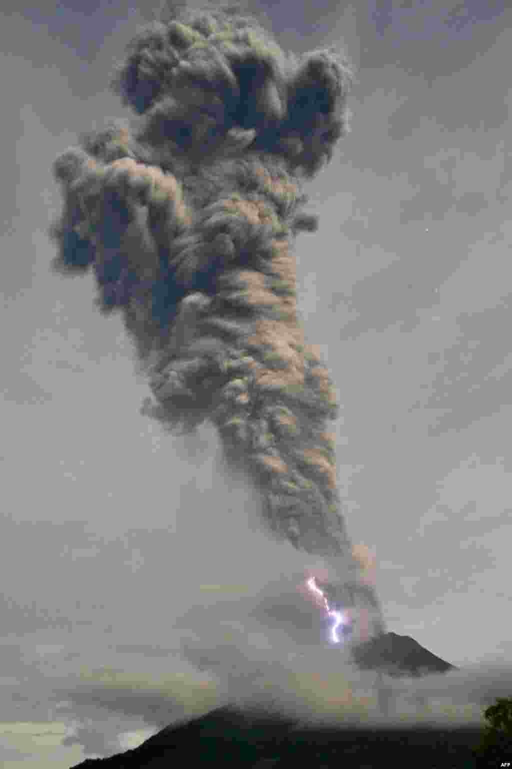 Lighting flashes as Sinabung volcano spews volcanic ash and hot smoke in Karo. Mount Sinabung on western Sumatra island, which has been erupting on and off since mid-September, shot volcanic ash around 10,000 meters into the air, according to Indonesia's Mitigation Agency.