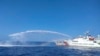 Sebuah kapal Penjaga Pantai China, kanan, menggunakan meriam air saat mendekati wilayah sengketa, Beting Scarborough di Laut China Selatan, 9 Desember 2023. (Foto: via AP)