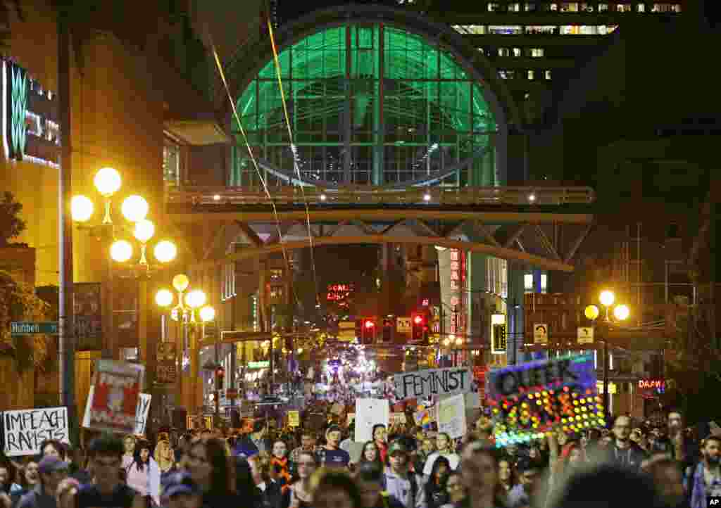 Hundreds of protesters march past the Washington Convention Center in downtown Seattle as they protest the election of President-elect Donald Trump, Nov. 9, 2016.