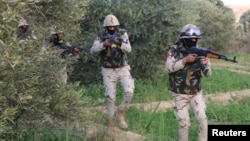 FILE - Egyptian Army officers are seen in the troubled northern part of the Sinai Peninsula during a launch of a major assault against militants, in Al Arish, Egypt, in this undated handout picture made available by the Ministry of Defense, March 4, 2018.