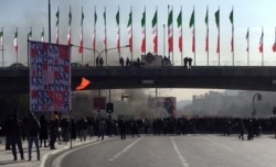 Smoke rises during a protest after authorities raised fuel prices, in the central city of Isfahan, Iran, Nov. 16, 2019.