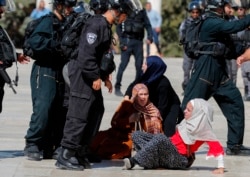Israeli security forces scuffle with Palestinians at the al-Aqsa Mosque compound in the Old City of Jerusalem on Aug. 11, 2019.