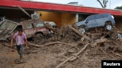 A man walks among the ruins after flooding and mudslides, caused by heavy rains leading several rivers to overflow, pushing sediment and rocks into buildings and roads, in Mocoa, Colombia, April 2, 2017.