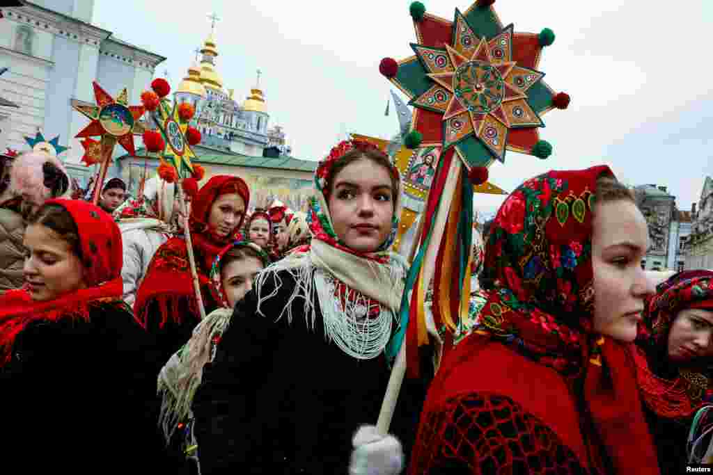 People wear traditional Ukrainian clothes as they mark Christmas Day with a carol singing event outside St. Michael's Golden-Domed Monastery in Kyiv, amid Russia's attack on Ukraine, Dec. 25, 2024.