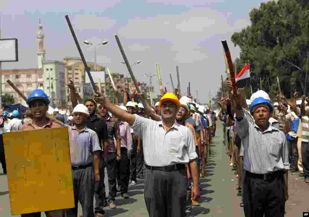 Supporters of Egypt's Islamist President Mohammed Morsi march in formation with sticks and protective gear outside of the Rabia el-Adawiya mosque near the presidential palace, July 2, 2013.