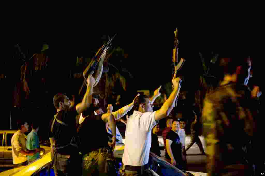 Syrian security personnel celebrate Bashar al-Assad's presidential re-election in Damascus, June 4, 2014.