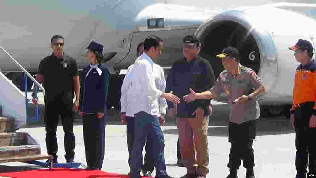 Indonesian President Joko Widodo, center, is greeted at the airport in Palu, on the island of Sulawesi, Oct. 3, 2018. (Y. Litha/VOA)