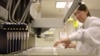 FILE - A technician loads patient samples into a machine for testing at Myriad Genetics, May 31, 2002.