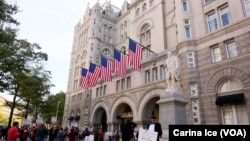 FILE - Hundreds protest Donald Trump at the opening of the International Trump Hotel at the Old U.S. Post Office Building in Washington, Oct. 26, 2016.