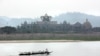 FILE - A boat on the Mekong River passes Chinese-run Kings Roman Casino in the special economic zone in Laos. (D. Schearf/VOA)