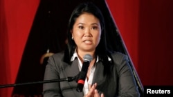 FILE - Presidential candidate Keiko Fujimori reads a statement to the press in Lima, Peru, June 5, 2011. 