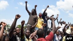 Protesters chant solidarity songs as they block the Lagos-Ibadan expressway, railing against police brutality and the killing of protesters by the military, at Magboro, Ogun state, Nigeria, Oct. 21, 2020.