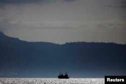 FILE - Chinese fishing trawlers anchor off the coast of Freetown, Sierra Leone, Nov. 18, 2012.