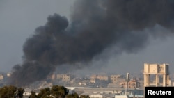 Smoke rises inside central Gaza strip following an airstrike, as seen from southern Israel