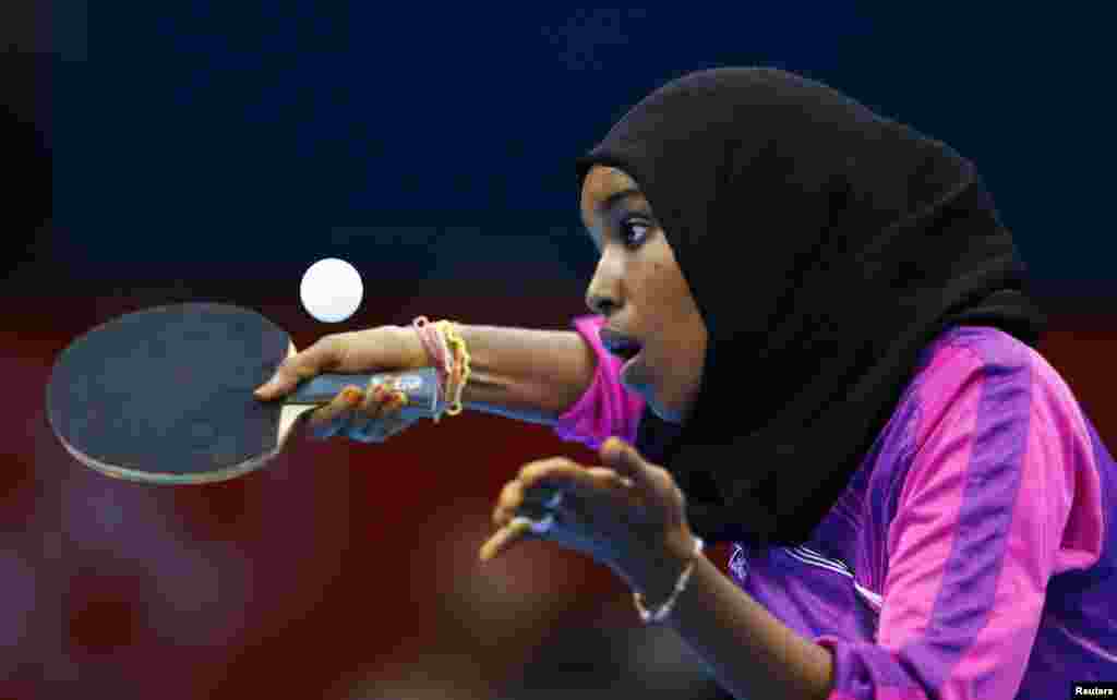 Djibouti's Yasmin Hassan Farah serves against Brazil's Caroline Kumahara during their women's singles preliminary round table tennis match at the ExCel venue of the London 2012 Olympic Games in London July 28, 2012.