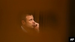 File - Oscar Pistorius sits in the high court for the fourth day of sentencing in Pretoria, South Africa, October 2014.