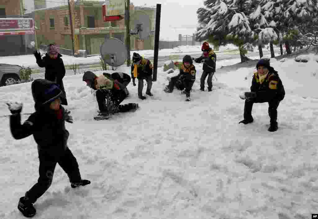 Syrian refugee children have a snowball fight at the mountain town of Bhamdoun, east of Beirut, Lebanon, January 9, 2013.