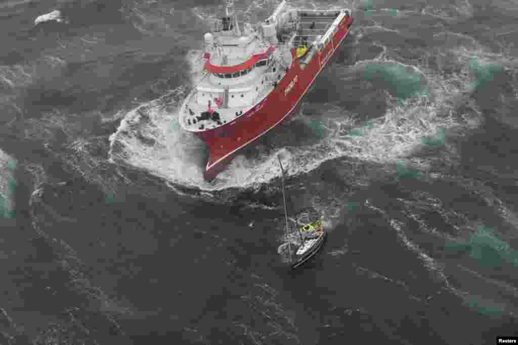 Research vessel Thor Magni rescues two people aboard a racing yacht in high seas in the mid-Atlantic, 250 nautical miles east of St. John's, Newfoundland , Canada, June 10, 2017. (Courtesy: JTFA/Canada Armed Forces)