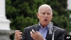 Gov. Jerry Brown addresses the crowd at a victims' rights rally, April 9, 2018, in Sacramento, California.